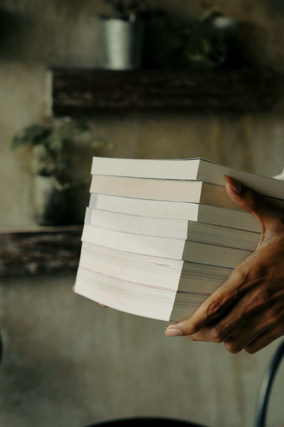Stack of paper documents and folders on a desk