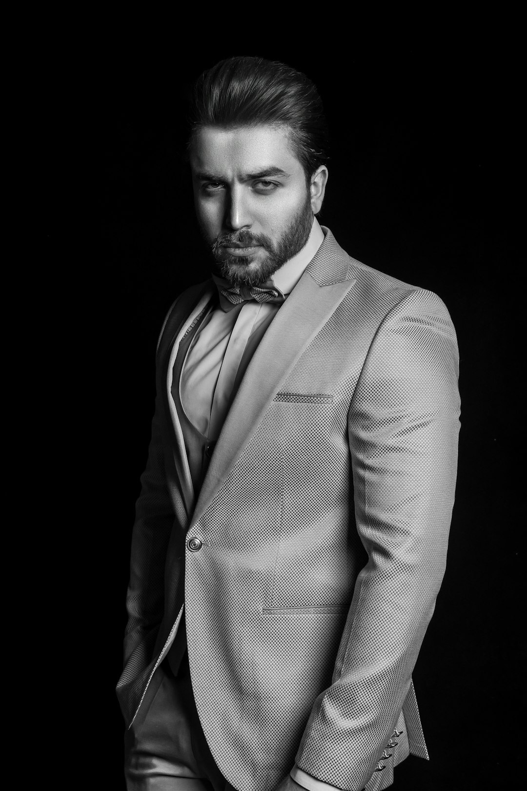 Studio portrait of a man with a beard in a suit