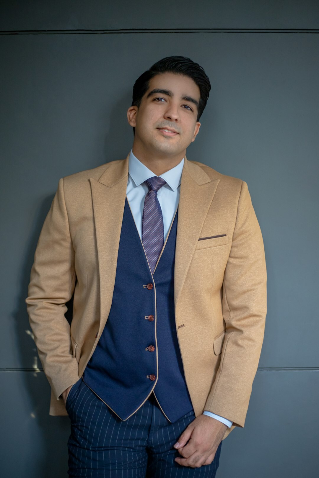 Studio portrait of a young man smiling in business attire